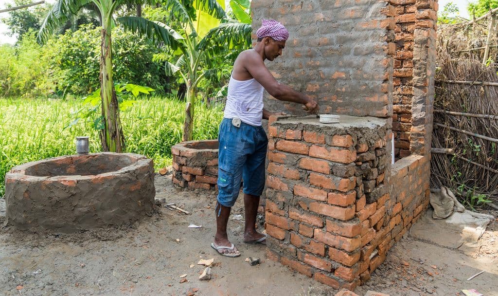 Audesh Kumar building a new toilet in a village, Muzaffarpur, Bihar. (AKDN/Christopher Wilton-Steer)