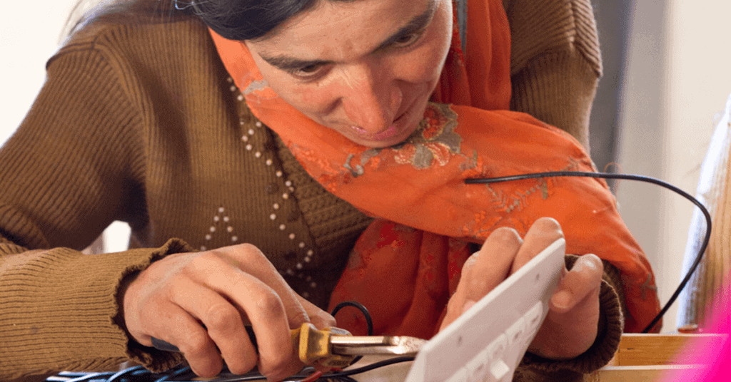 Pakistani woman practicing electrician skills.
