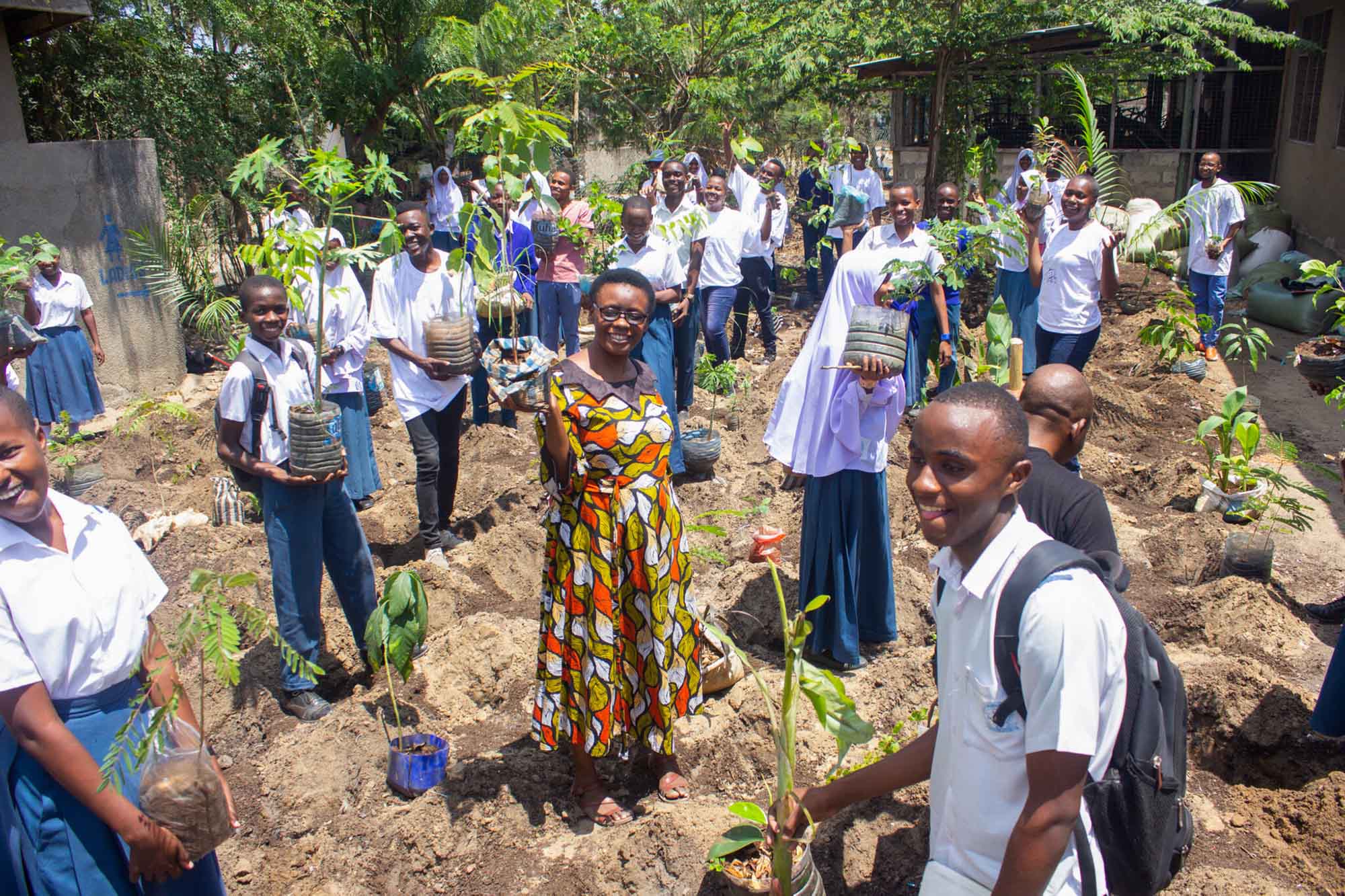 Students, teachers, and volunteer parents engage in planting micro forests at Mbande secondary schools at Temeke MC Dar es Salaam.