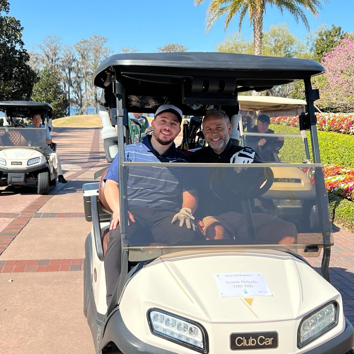 2024 Florida Golf Attendees in a golf cart.